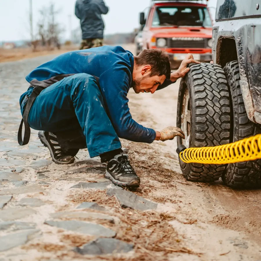 A man pumps air wheel with a compressor
